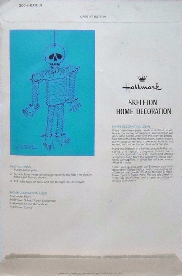Back package layout of Hallmark honeycomb Skeleton Home Decoration (1970's) photographed against a dark blue graveyard - shown here as part of research for The Halloween Retrospect, Volume 3 - a new guidebook series for collectors.